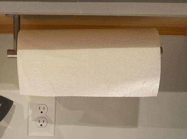 Paper towel holder installed under cabinet