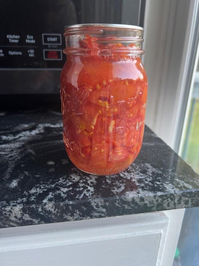 Mason jars filled with canned tomatoes