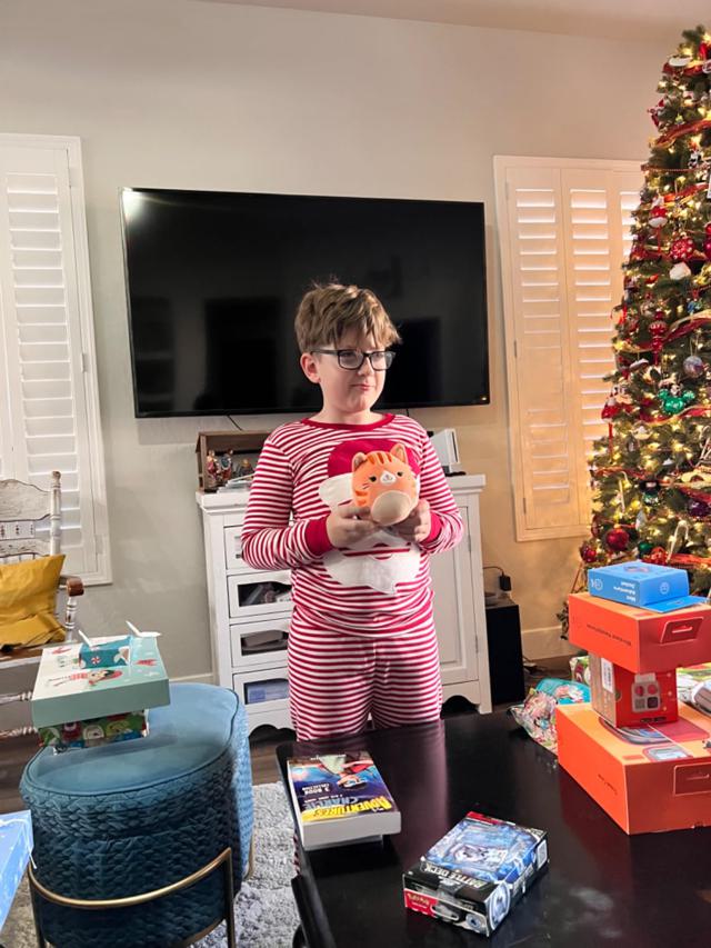 Kids opening presents in Christmas pajamas