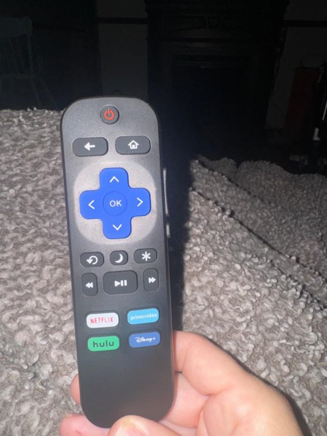 Roku TV remote in use